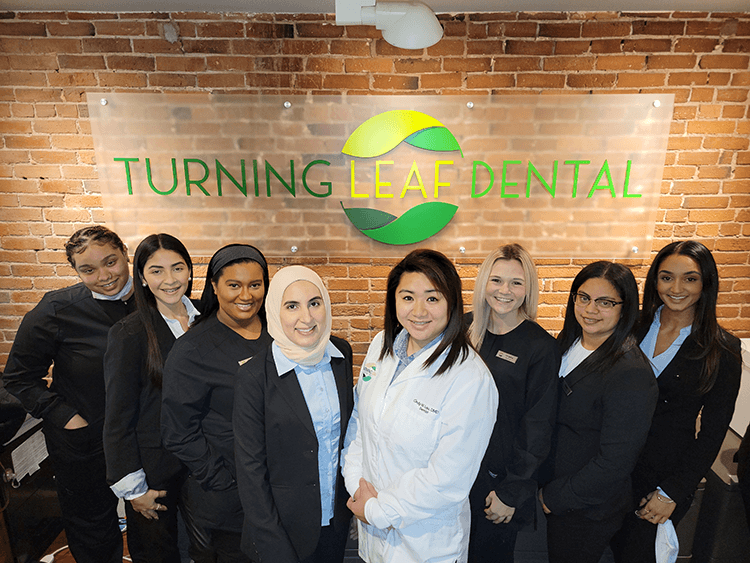 Turning Leaf Dental team members smiling in reception area